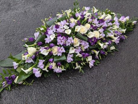 lilac, purple and white casket with calla and freesia